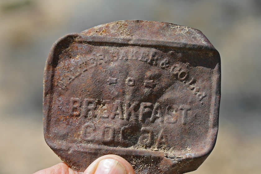 An embossed Walter Baker & Co., Ltd. cocoa tin.
