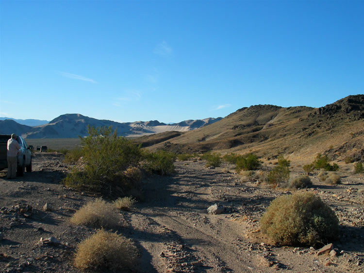 We're getting close.  Access to this area is slow due to the marginal roads.  Here we've stopped to take in our first view of the sand dune that we'll camp near tonight.