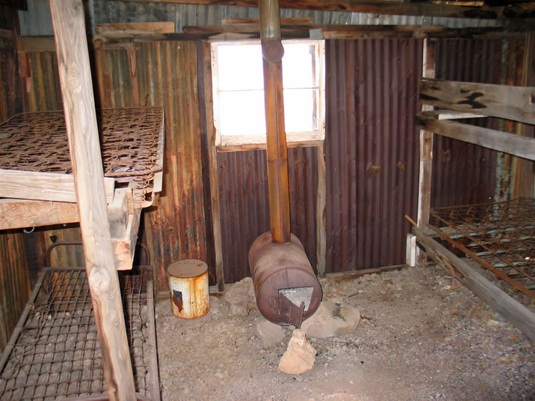 There are two sets of double bunks flanking the stove.