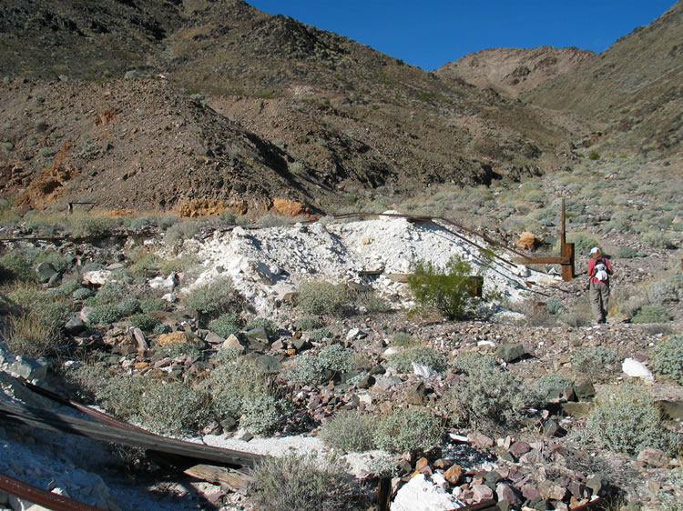 Old ore cart tracks and other debris litter the area.