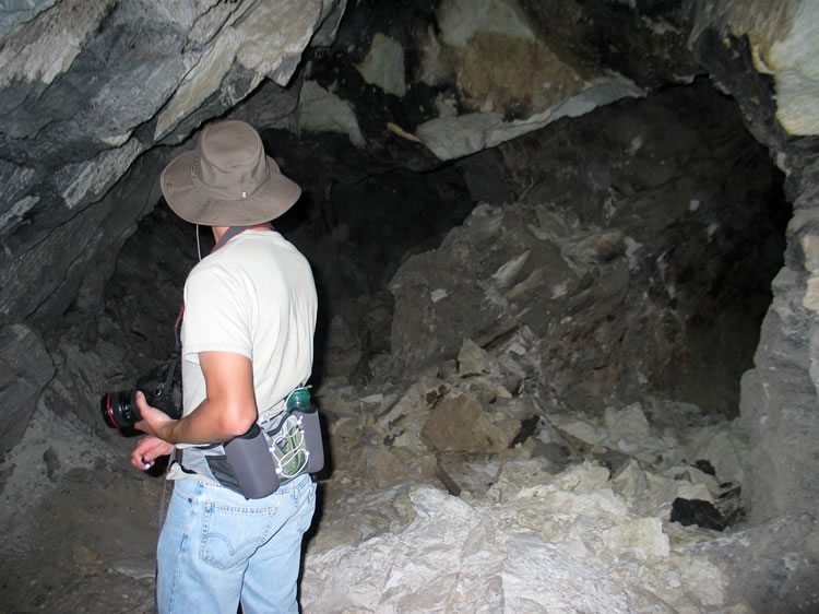 Guy checks out a caved-in side tunnel.  Notice the little button light in Guy's right hand.