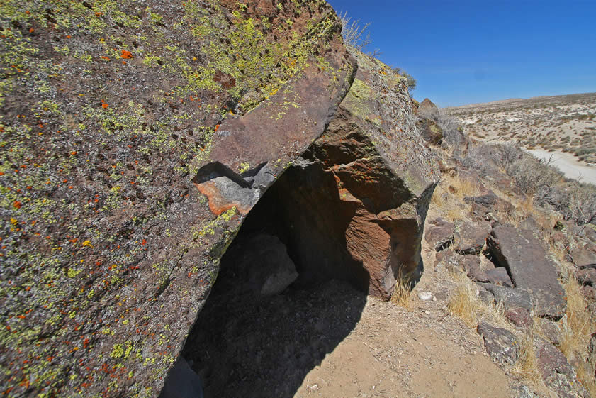 This nearby rock shelter is also interesting.  It's quite tiny and only suitable for one seated person.  There are petroglyphs on all three boulders that form the shelter.  However, they are quite old and have been almost completely covered by lichen growth.  In additon, there are two interior surfaces that have also been incised.  The only panel that shows up reasonably well in a photograph can be seen in the following picture.