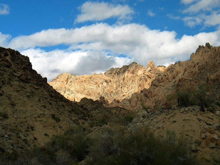 As we exit the canyon, the sun lights up the rocky peaks behind us.