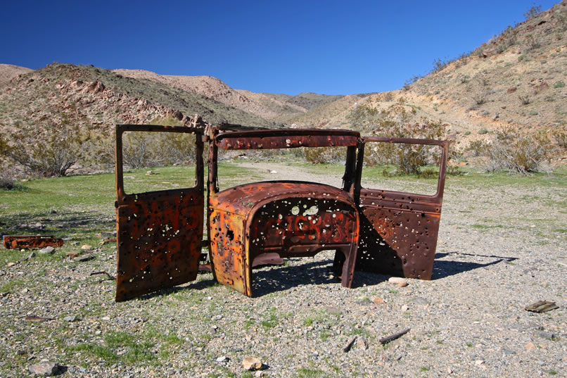 The well ventilated remains of this old auto guard the approaches to the mine.