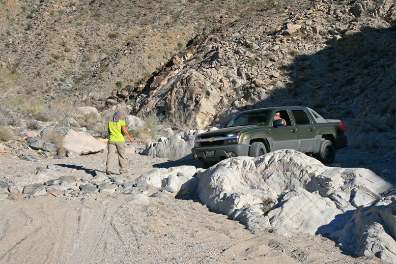 In the lower stretches of Pinkham Canyon there are a few rocky ledges to negotiate but again nothing too extreme.   Here Jamie lends a hand while Mohave threads the Tank around some boulders.