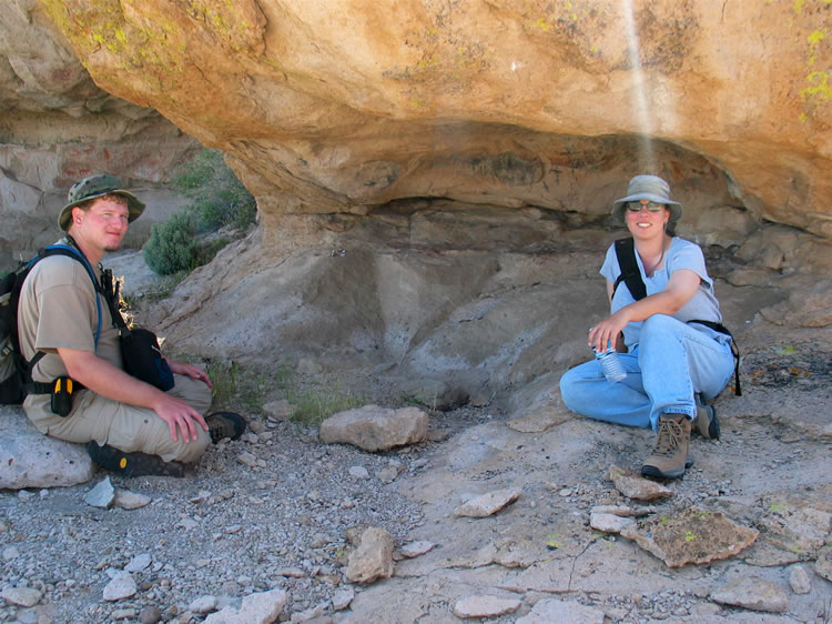 Dezdan and Alysia taking a break in the shade with the pictos visible behind them.