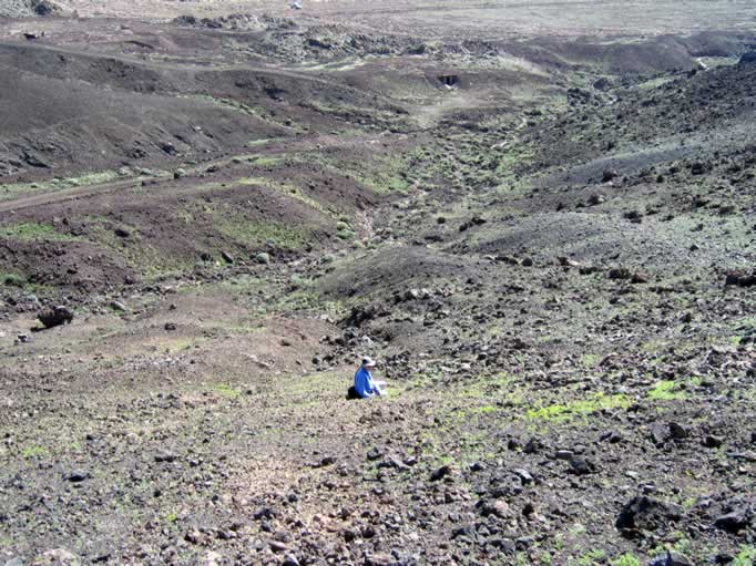 Niki explores a trail on the side of the slope.  You can see our truck in the background.