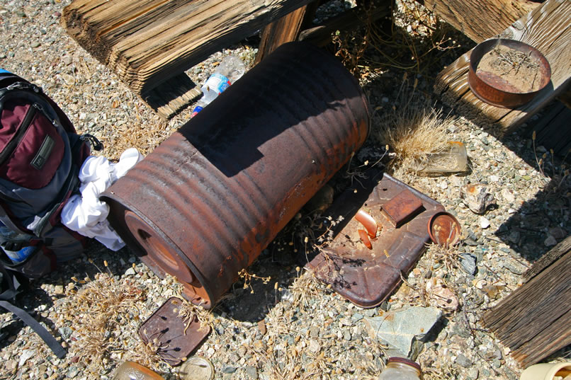 Several large, ribbed carbide barrels, such as you see here, are strewn around the area.  (Note: That plastic water bottle behind the carbide barrel is ours and has has just blown off the table.  It'll get stuffed back in its pack and come out with us.  We only leave footprints and take back photos and memories!)