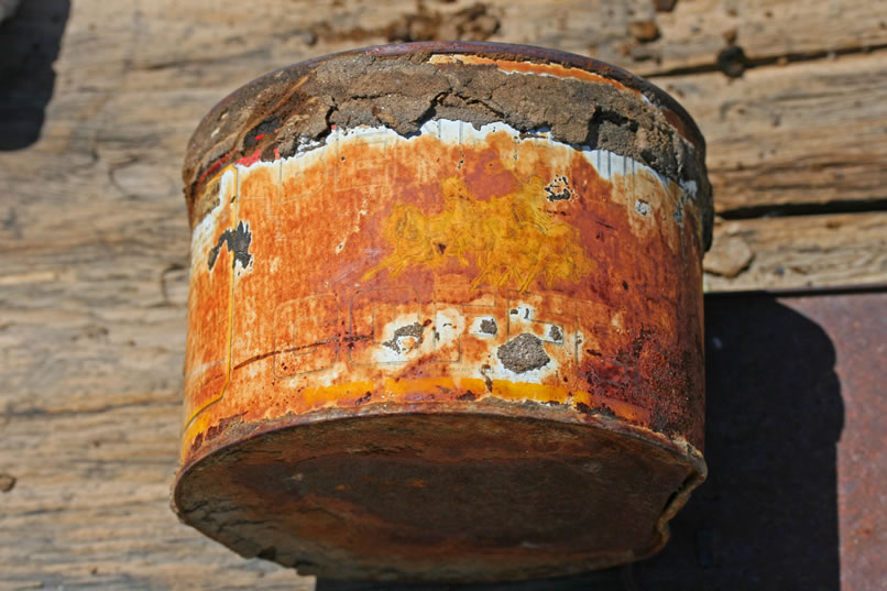 This crusty old container turns out to be a can of Ben Hur Coffee.  You can faintly see the horse drawn chariot, which was its logo.  In the next photo, a close-up, you can see it more clearly.