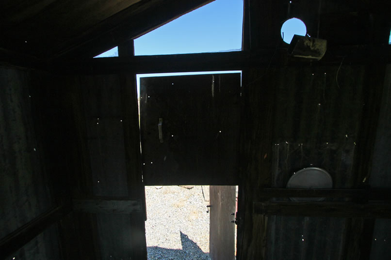 A look at the door from inside the cabin.  Notice the circular cut out to the right of the door, probably for a stove pipe.