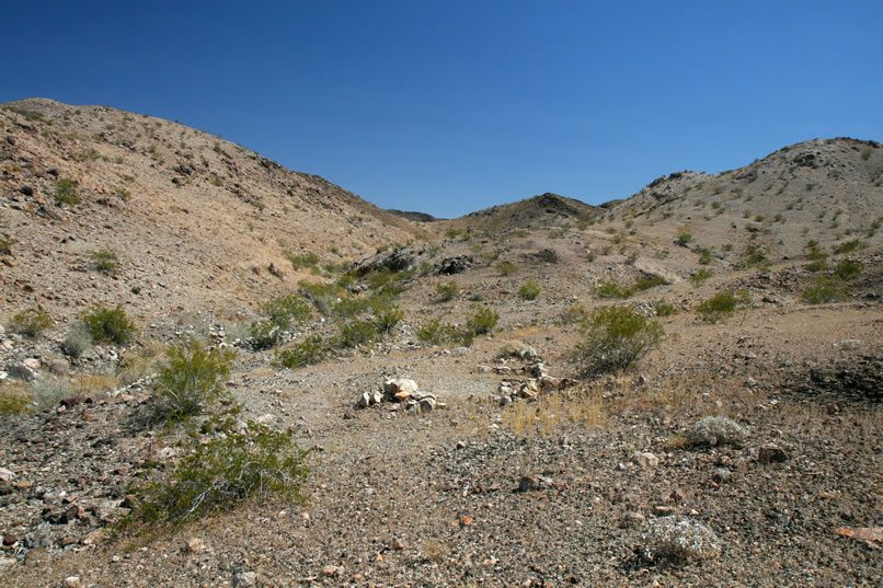 Just up from the mouth of the canyon, we come upon a level spot with a rock outline that might have supported a small tent cabin.