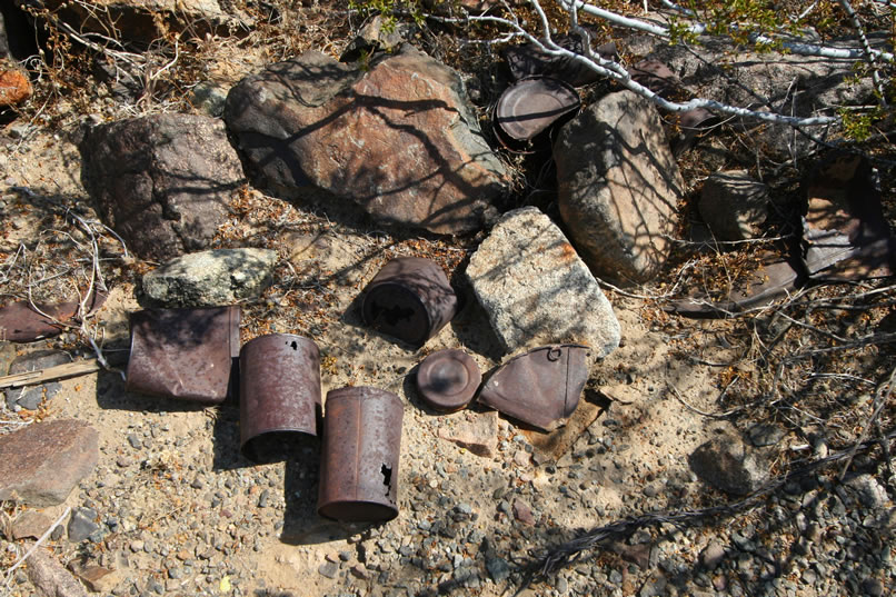 We decide to start exploring by first checking out the area around this large stone foundation.  There are plenty of cans scattered around.