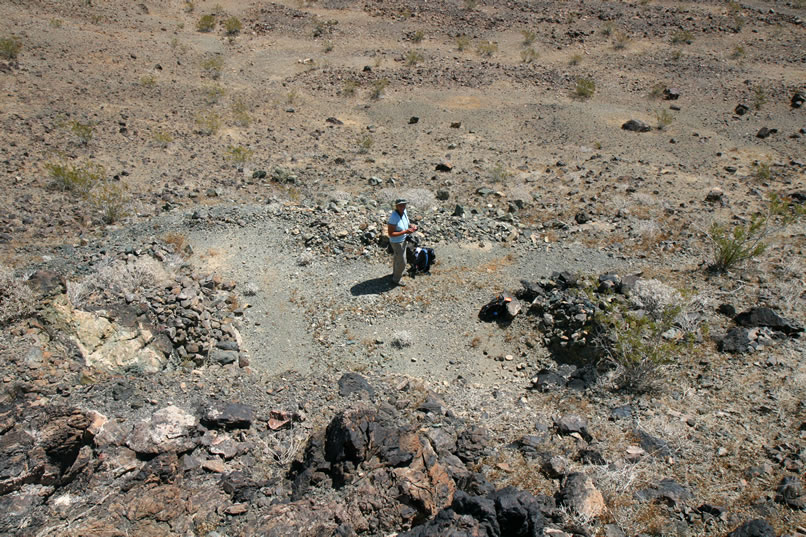 As she climbs down, she also gets a bird's eye view of Jamie on the tailings pile at the tunnel entrance.