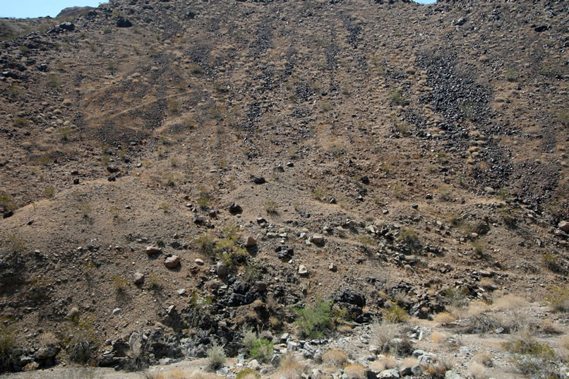 Before we descend, we take a telephoto shot of the numerous zig-zag foot paths that climb the steep slope of the nearby hill. 