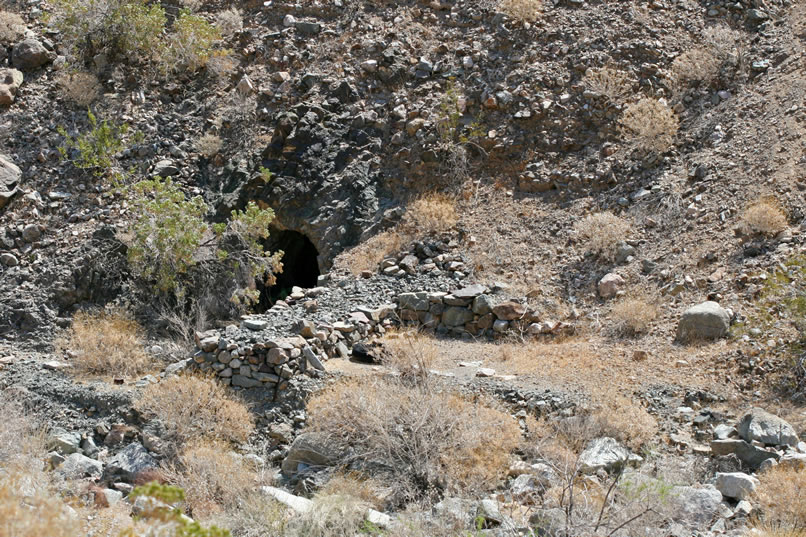 As we look down into the deep wash below the mine camp, we can see stacked rock work and a mine entrance.  Here's a telephoto view.
