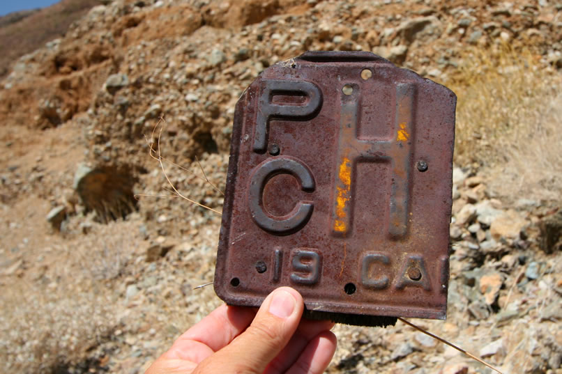 On the way down, we find part of an old California license plate.  The plate seems consistent with the style and color used in 1932-33.  The PC designation would have stood for "Pneumatic tire - Commercial."