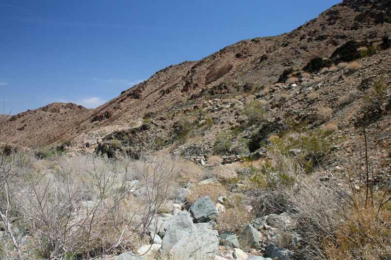 This is a view from the wash bottom as we pick our way down to the stacked stones and mine entrance.