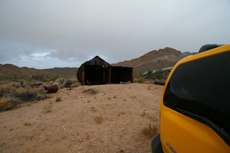 A look back at the shed with dark clouds blowing up from behind it.