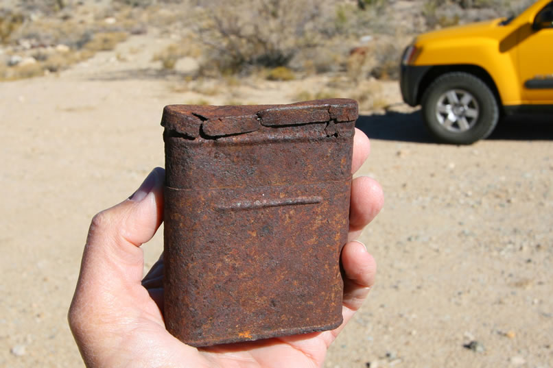 This old collapsible tobacco tin is designed so that the top telescopes into the base as the tobacco is used in order to make it easier to reach the bottom of the tin.