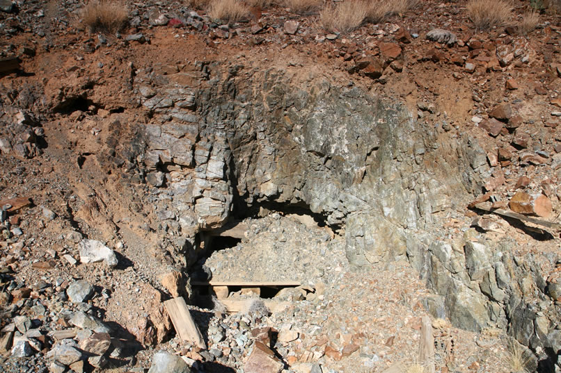 We also notice a caved in adit near the vertical shaft.