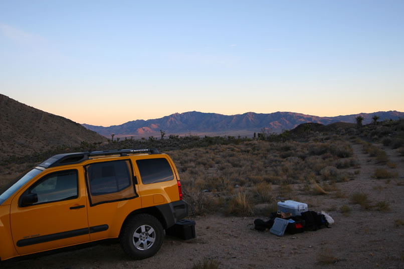 The Dzrtgrls fold the Desert Canary's rear seats flat and lay out the sleeping bags while admiring the sunset glow on the New York Mountains.  Note the bug screens for the rear windows.  These have been invaluable in keeping the gnasty gnats away!