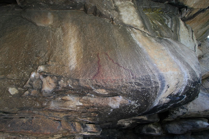 In the shade under the overhanging roof, it's difficult to clearly make out the pictograph elements.  At first they seem rather simple, but a closer inspection shows lots of subtle details that are easy to miss.  Roll your mouse over the image to see the sinuous line that joins the two wide arms of the inverted funnel shape.