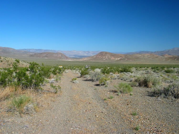The dim two track that we've been following will soon enter the Naval Air Weapons Station at China Lake.  You can just see the signs in the distance.