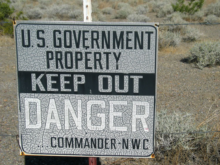 We love the crackle finish background of these signs that adorn a short stretch of barbed wire fence.  Who knew that the military was so artistic?