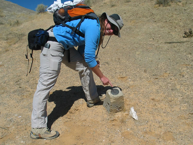 Just above what appear to be outhouse ruins we find a benchmark.