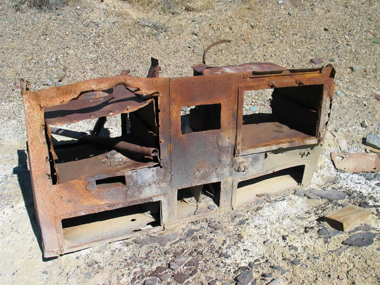 Adjacent to the stone cabin are other scattered ruins and some low stone walls hinting at other structures.  Just beyond those we find this old stove.