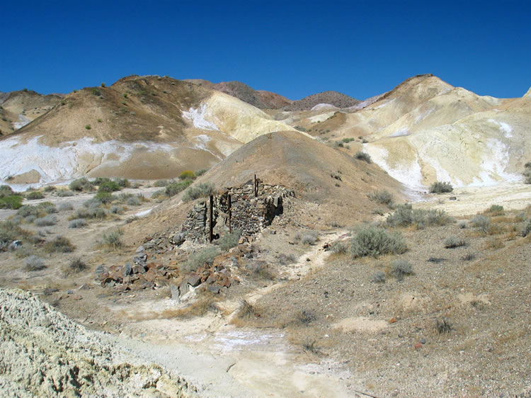 We take a couple of looks over our shoulders at the site of the mine camp before we set off down the wash to try to find some remnants of the old monorail.