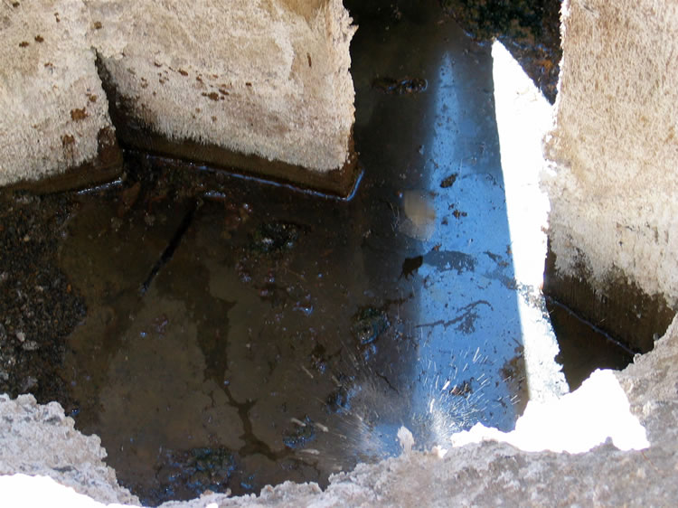 As you can see from the splash of the rock, the lower part of the shaft is sitting in water.