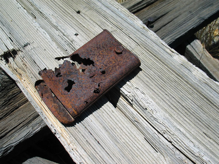 We find a tobacco tin affixed to one of the wood supports.