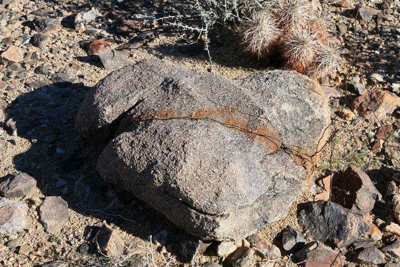 Confirmation of the tent cabin hypothesis comes in the form of a large rock wrapped with wire which forms a solid anchor point for a guy line to the tent.