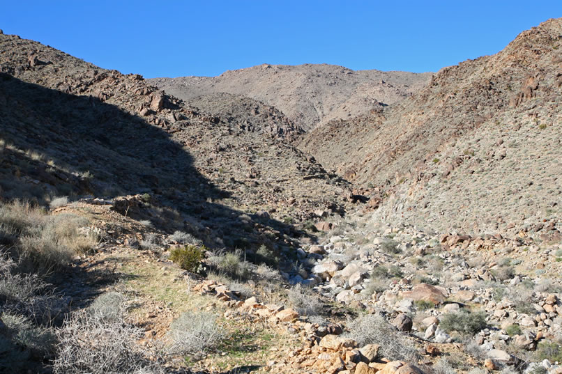 Shortly, we're astonished to see what must have been a considerable expenditure of time and effort, a shelf road that snakes its way up the canyon!  One look at the impassable, boulder choked wash below shows that the miners had little option but to create this amazing road.