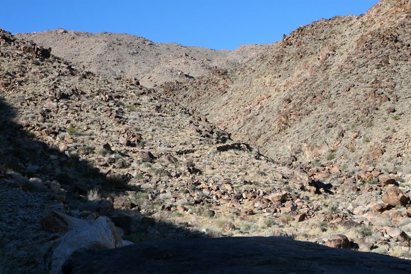 In this telephoto view, you can clearly see the stacked rocks where the shelf road rounds the point ahead.