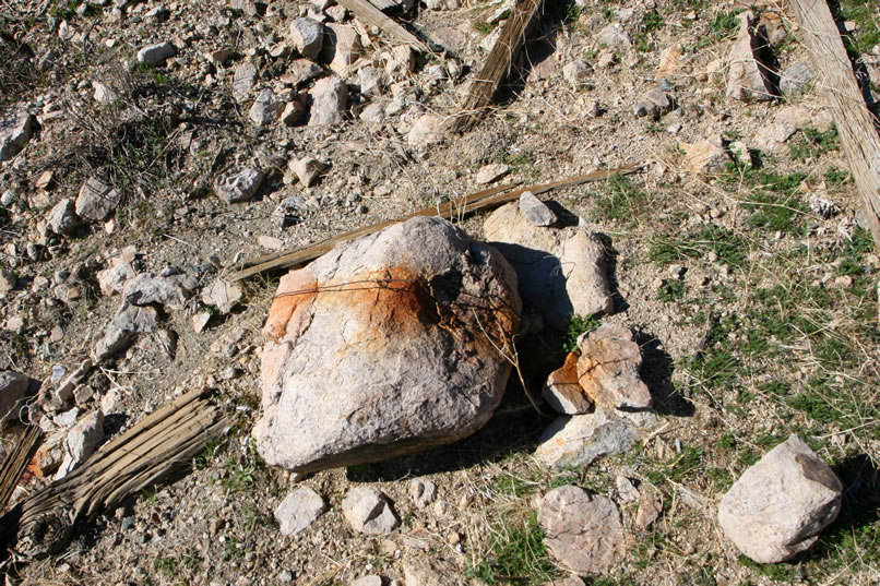 Although there are a scattering of dry and weathered boards around, it appears from this anchor rock that at least the roof and possibly the upper walls of the structures here were of canvas.