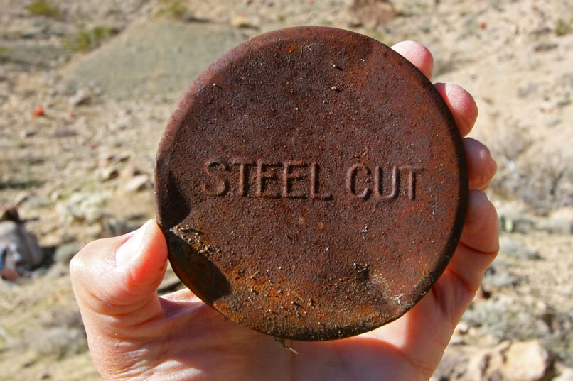 This could be the top to a tin of oats or coffee, both of which often advertised that they were "Steel Cut."