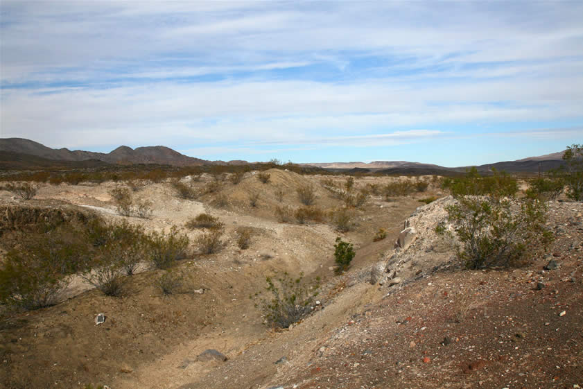 Several deep excavations bear witness to the energetic work of rockhounds from the 1950's and '60's.  This area produced wonderful chapinite, or brecciated agate nodules.  What was unique about these was that the original silica gel in the agate was subject to additional movement before it hardened.  This made it possible for another solution to be deposited in and around the original material.  The resulting unique patterns and coloring made this material much sought after.