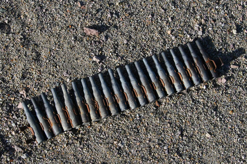 One of the group members calls us over to look at some belted blank ammo that he's found.