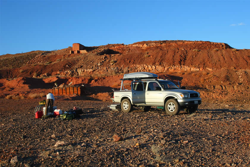 Setting up camp.  The sunset glow adds to the already ruddy coloration of the iron oxides and abundant barite that are also found at the mine.