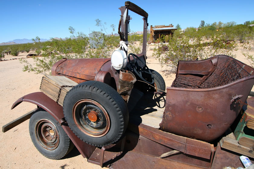 A side view shows a nifty rifle scabbard behind the convenient spare tire mount.