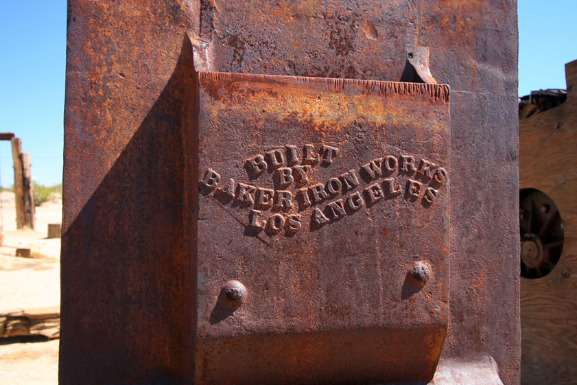 A close up of the manufacturer's mark on the frame of a two stamp mill that is identical to the one at Wall Street Mill in Joshua Tree National Park.