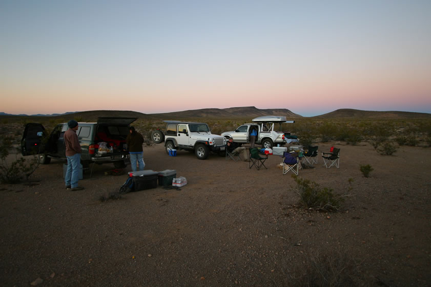 Finally, we make camp by the last rays of sunlight.  It looks like a good spot.  It's flat and open and has a good feel. The plan is to cook up some quick grub and then kick back around the campfire ring.