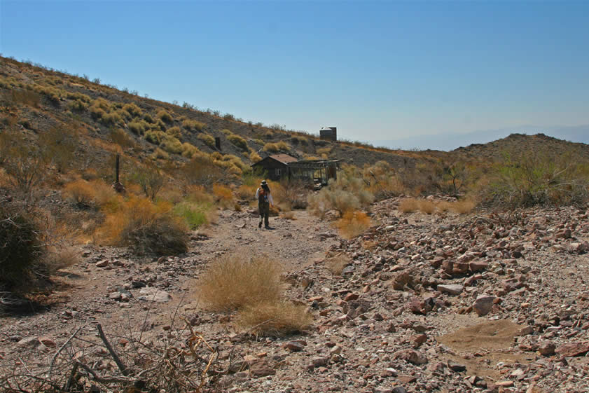 We spot a cabin down the wash from the tunnel and head down to take a look.