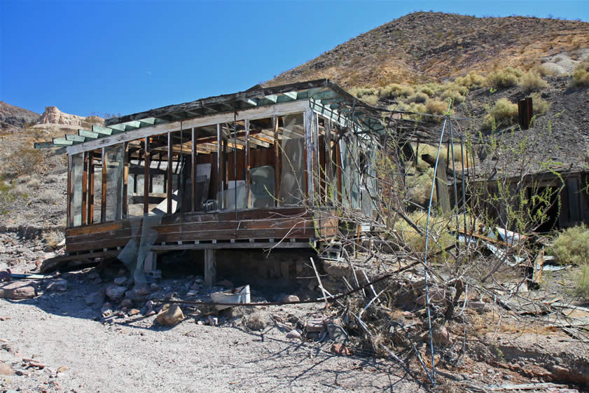 Erosion from the wash has severely undermined the large screened front porch.