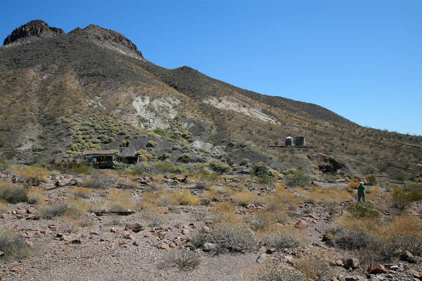 As we leave the can dump, we take this wide angle photo looking back at the cabin, water tanks, and old milling ruins.