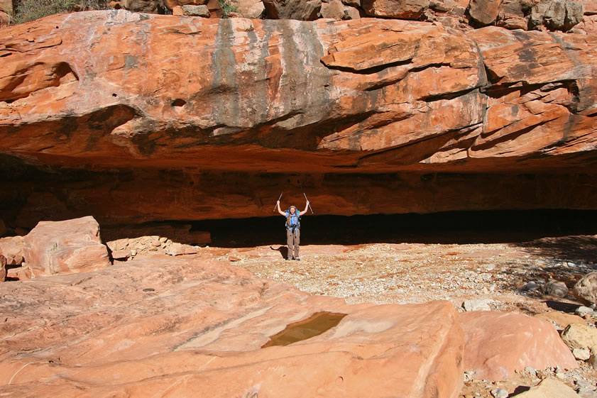 Niki shows how tall the rock overhang is.