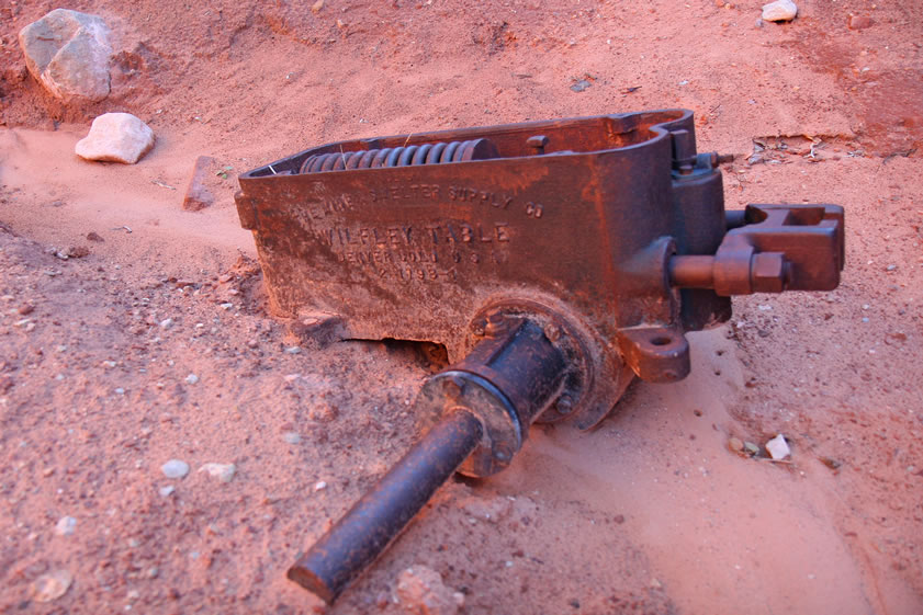 This is part of a Wilfley table, which was a mechanism that separated gold from waste rock by shaking it across a slanted table.  The gold, being heavier, would settle into the riffles of the table while the waste rock would be shaken off.