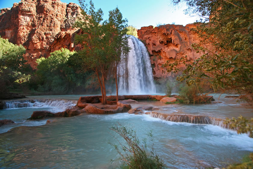 The water of Havasu Creek is highly mineralized.  This is what causes the spectacular blue-green color.  Another effect of the carbonate precipitate in the water is that it builds walls and forms pools.  Here, and in the next couple of photos, you can see the dams, called pour-offs, that have resulted from the mineral content.  Also, if you look to the right of the falls, you can see what looks like droopy, melting rock.  This is also the result of the carbonate, or lime, in the water that is constantly building and changing the face and the course of the falls.